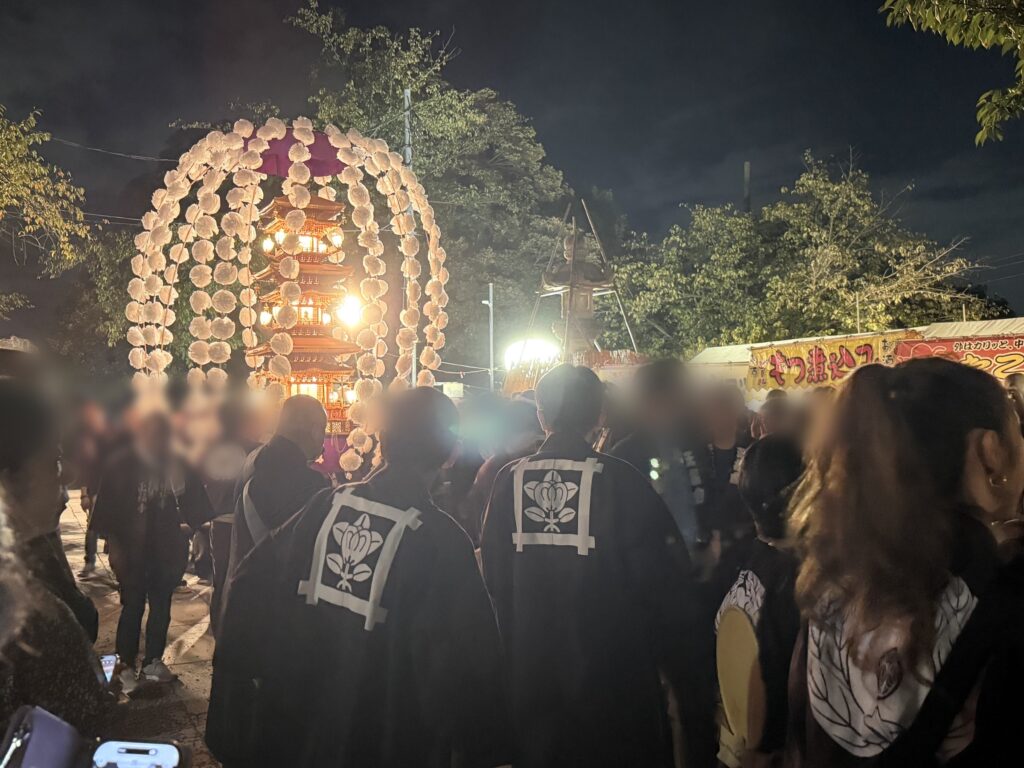 五重塔を模した万灯と講中の法被