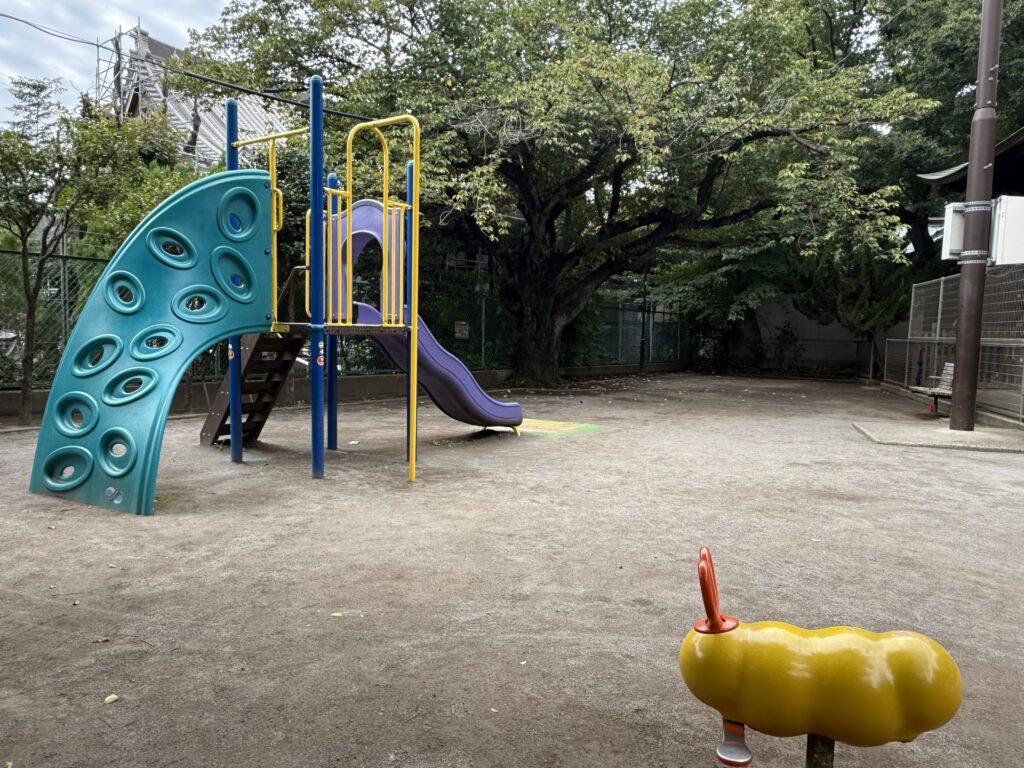 旗岡児童遊園の写真(紫の滑り台の複合遊具といもむしのスプリング遊具)